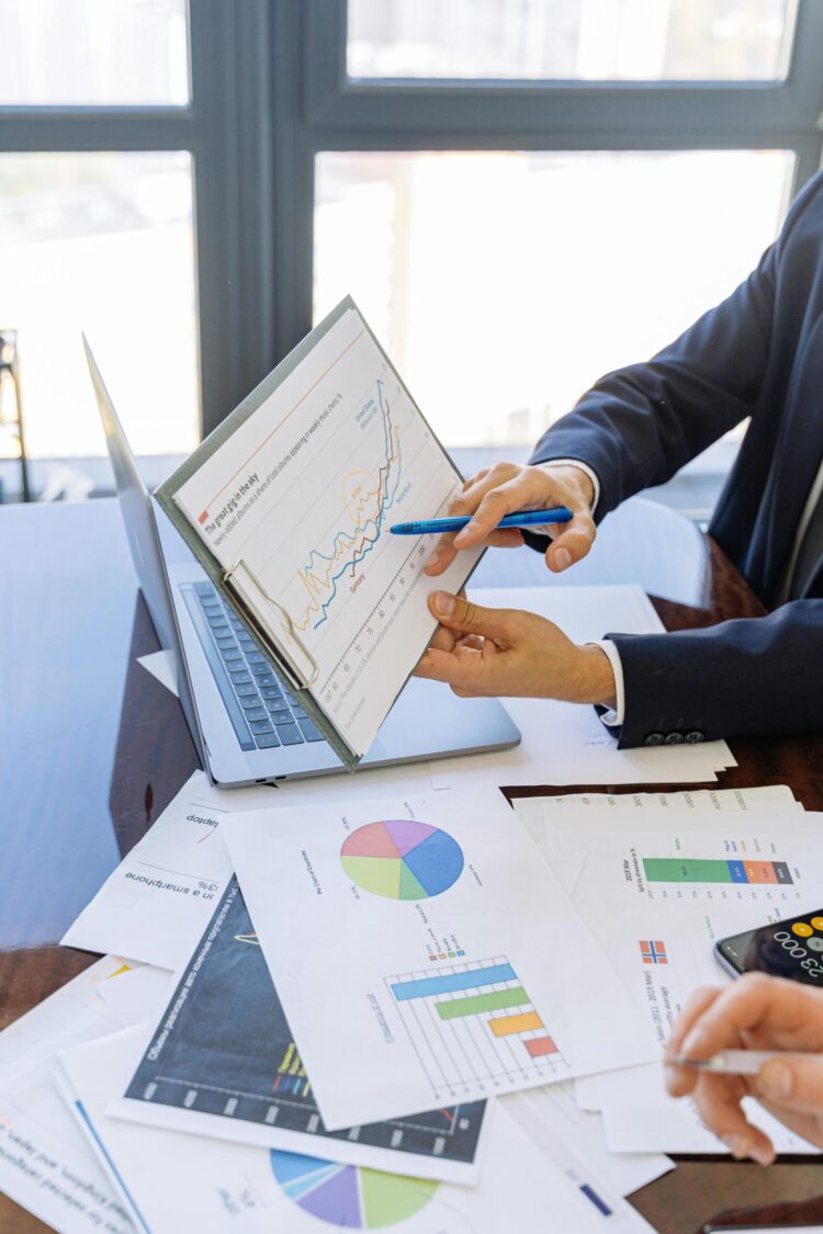 Free Business professionals discussing financial graphs and charts in an office setting. Stock Photo