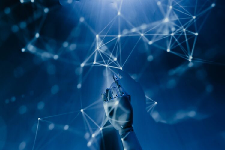 Free A robotic hand reaching into a digital network on a blue background, symbolizing AI technology. Stock Photo